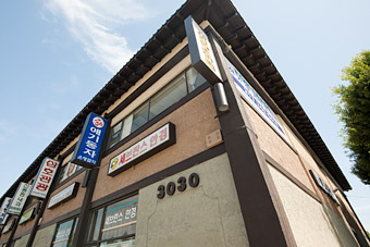 Shopping Center - north side shot from low angle showing painted rafters and eaves, Olympic Boulevard, Koreatown Los Angeles